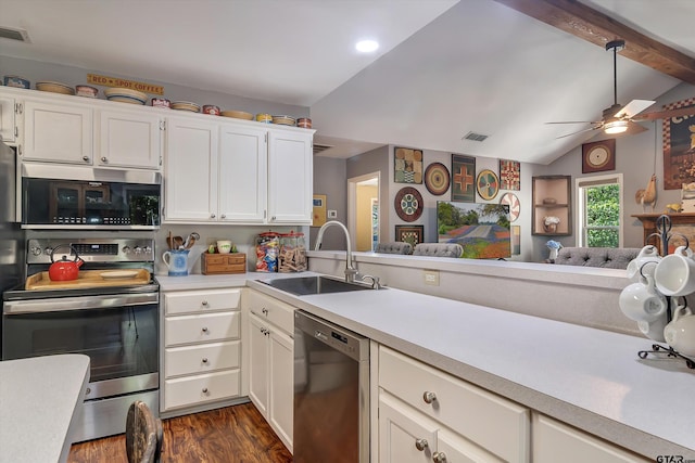 kitchen with vaulted ceiling with beams, stainless steel appliances, dark hardwood / wood-style flooring, sink, and white cabinets