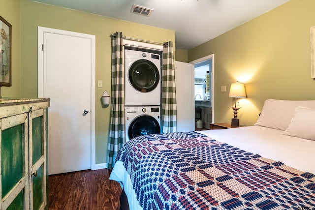 bedroom featuring dark hardwood / wood-style flooring and stacked washer and clothes dryer