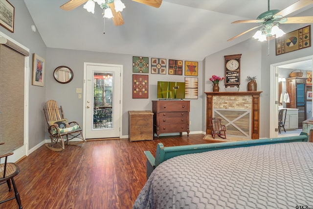 bedroom with a fireplace, dark hardwood / wood-style floors, access to exterior, vaulted ceiling, and ceiling fan