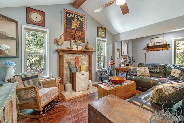 living room with hardwood / wood-style flooring, ceiling fan, and vaulted ceiling with beams