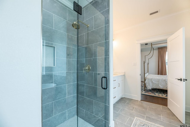 bathroom with tile patterned floors, vanity, an enclosed shower, and ornamental molding