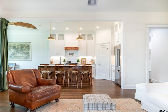 living room with beamed ceiling and dark hardwood / wood-style flooring