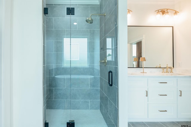 bathroom featuring tile patterned flooring, vanity, and walk in shower