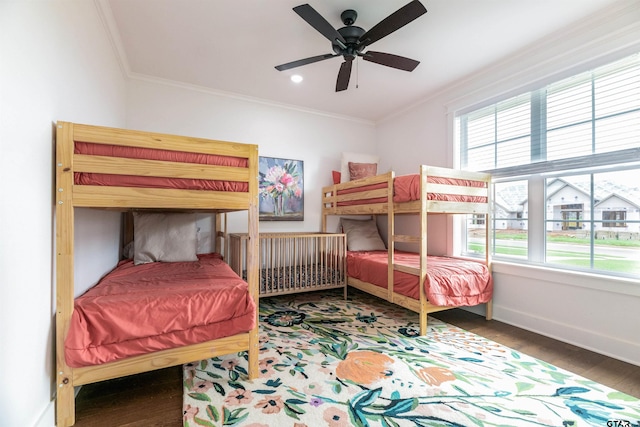 bedroom featuring multiple windows, ceiling fan, and ornamental molding