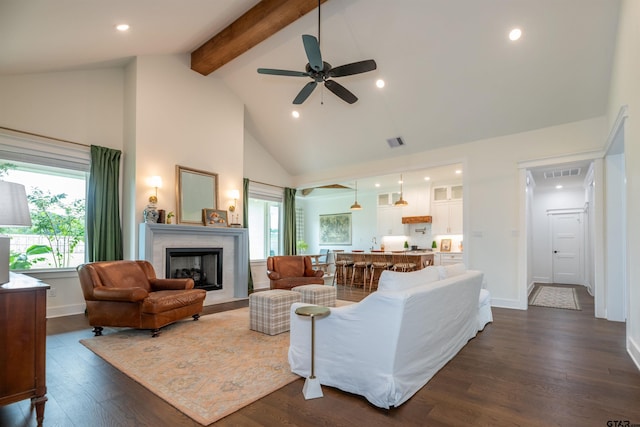 living room featuring beam ceiling, ceiling fan, high vaulted ceiling, and dark wood-type flooring