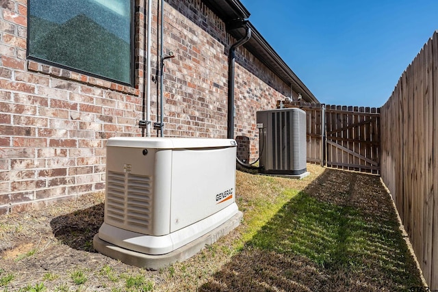 7584 Princedale, Tyler, TX 75703 - exterior view of a power unit, cooling unit, a gate, brick siding, and fence