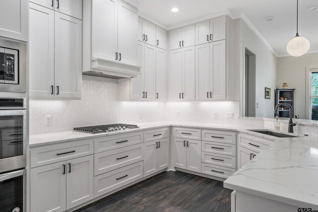 7584 Princedale, Tyler, TX 75703 - kitchen featuring a sink, stainless steel appliances, dark wood-style flooring, white cabinets, and decorative backsplash