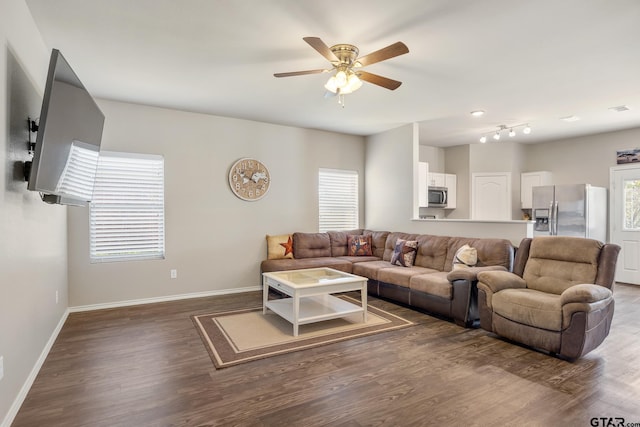 living room with dark wood-type flooring and ceiling fan