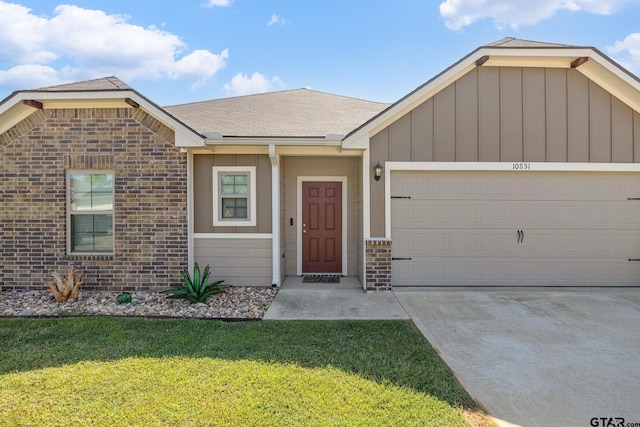 ranch-style house with a garage and a front lawn