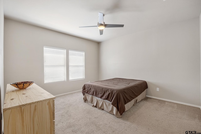 bedroom featuring ceiling fan and light carpet