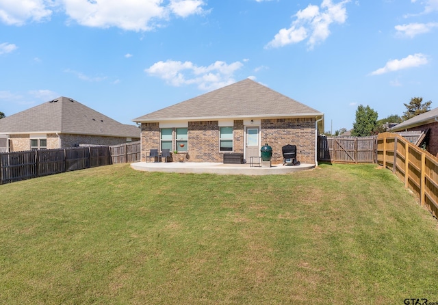 back of house featuring a yard and a patio area