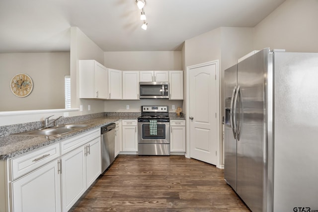 kitchen with light stone counters, stainless steel appliances, dark hardwood / wood-style flooring, sink, and white cabinets