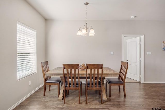 dining room featuring an inviting chandelier, dark hardwood / wood-style floors, and plenty of natural light