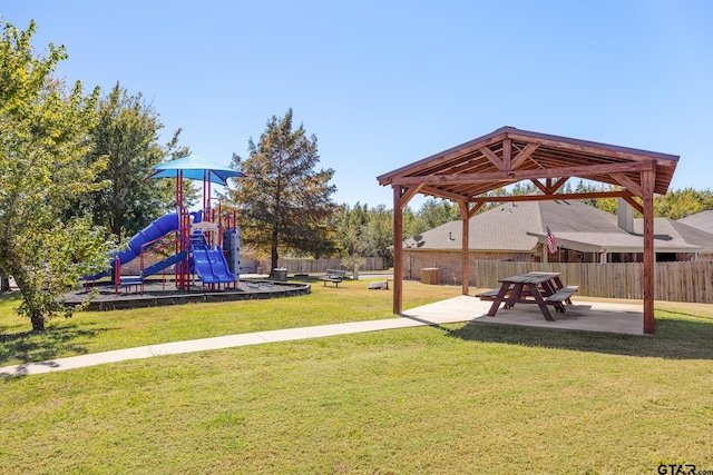 view of yard featuring a playground and a patio