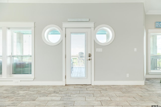 foyer featuring ornamental molding