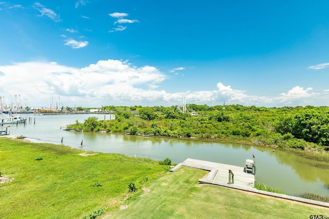 view of dock featuring a lawn and a water view