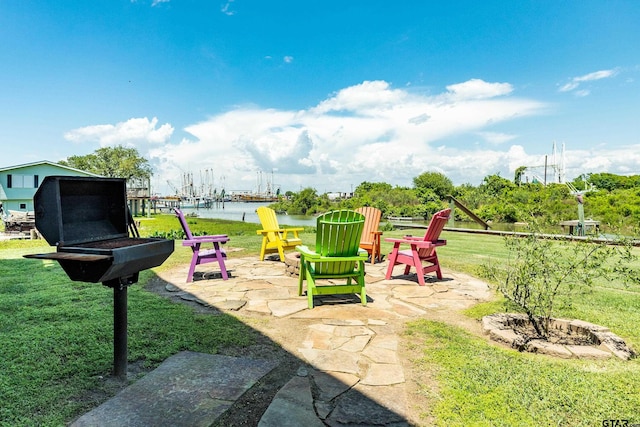 view of jungle gym with a water view, a patio area, and a lawn