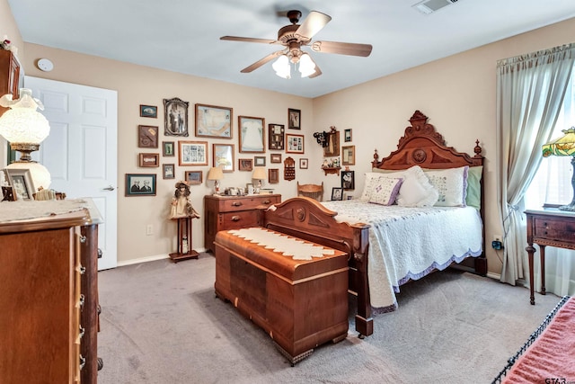 bedroom featuring visible vents, baseboards, carpet floors, and ceiling fan