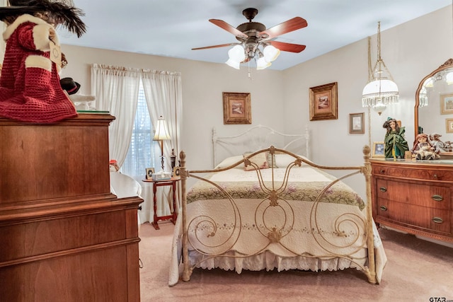 bedroom featuring light colored carpet and ceiling fan