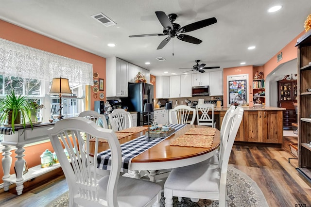 dining room featuring dark wood-style floors, visible vents, and recessed lighting