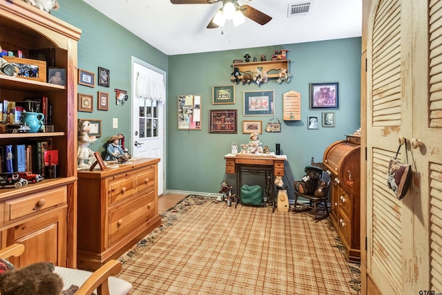 office area featuring a ceiling fan, visible vents, and baseboards