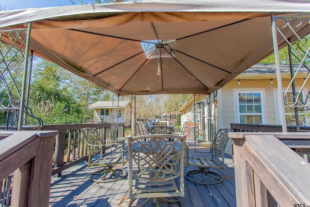 wooden terrace featuring outdoor dining area