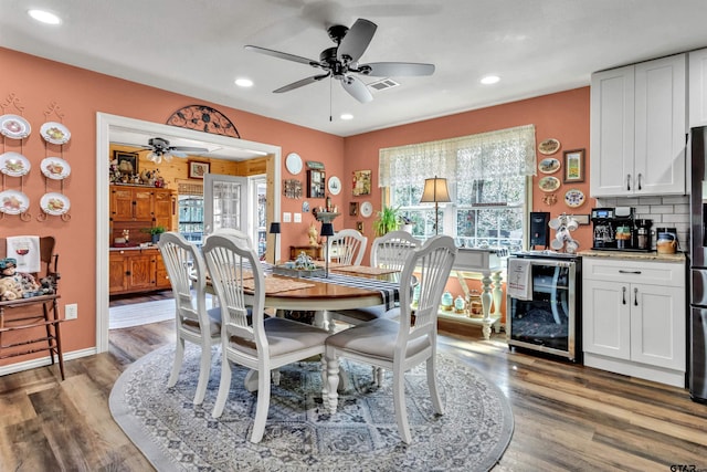 dining space featuring wood finished floors, recessed lighting, beverage cooler, and ceiling fan