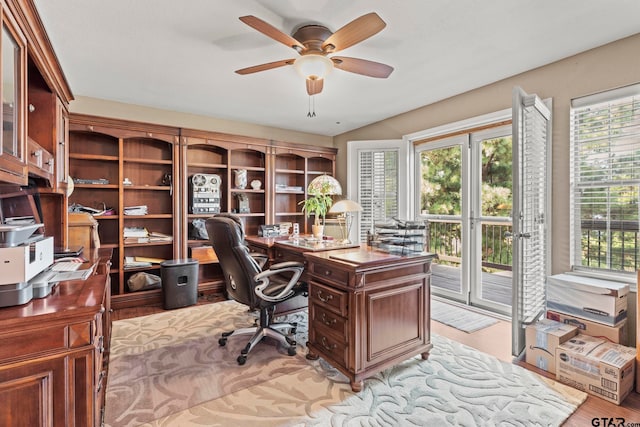 office area with light hardwood / wood-style floors and ceiling fan