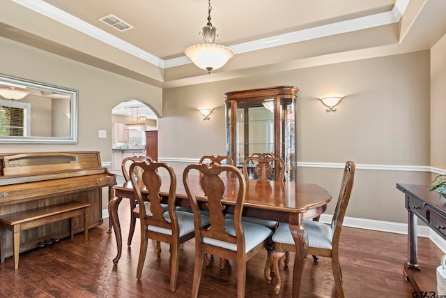 dining room featuring crown molding and dark wood-type flooring