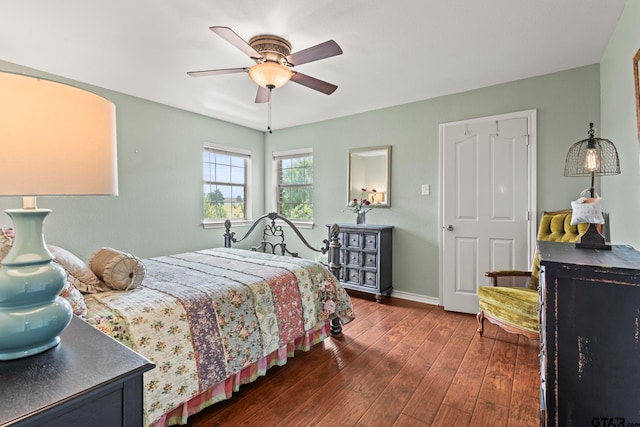 bedroom with dark hardwood / wood-style flooring and ceiling fan