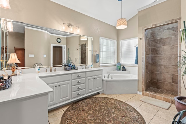 bathroom with tile patterned flooring, vanity, and plus walk in shower