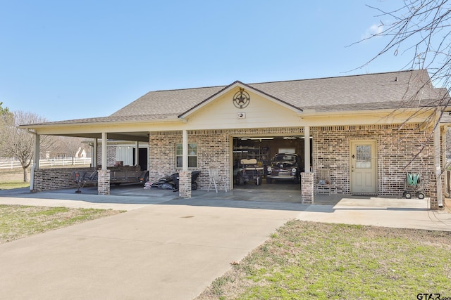 exterior space featuring a garage, a carport, and a front yard