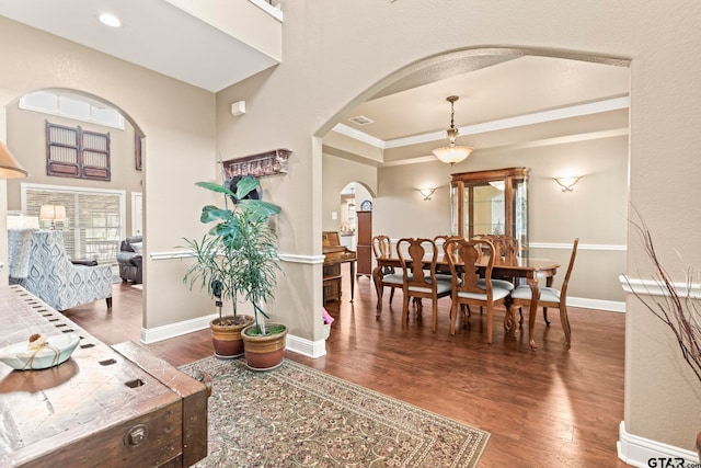 interior space featuring a tray ceiling and hardwood / wood-style floors