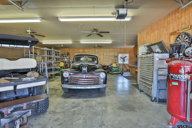 garage featuring a garage door opener and wood walls