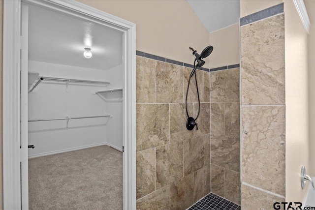 bathroom with a tile shower