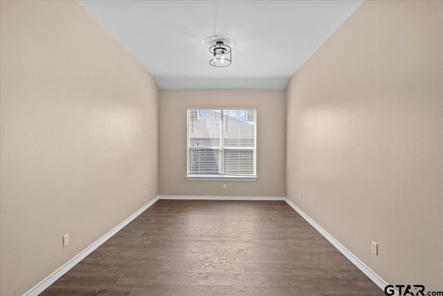 empty room with dark hardwood / wood-style floors