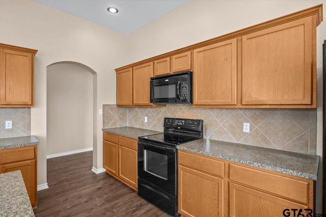 kitchen featuring tasteful backsplash, dark hardwood / wood-style flooring, and black appliances