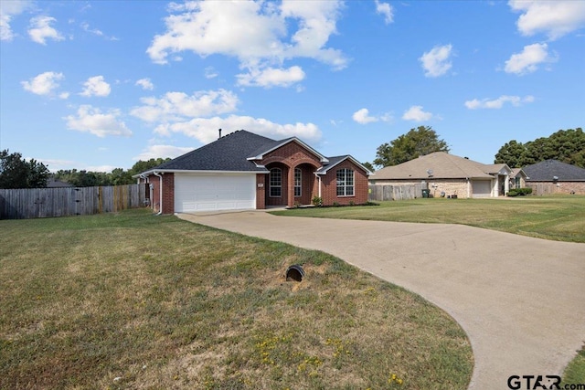 single story home featuring a garage and a front yard