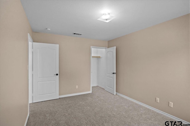 unfurnished bedroom with light colored carpet