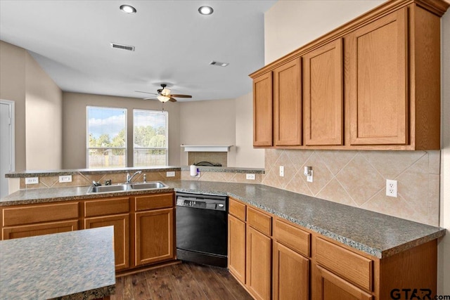 kitchen featuring dishwasher, sink, dark hardwood / wood-style floors, backsplash, and kitchen peninsula