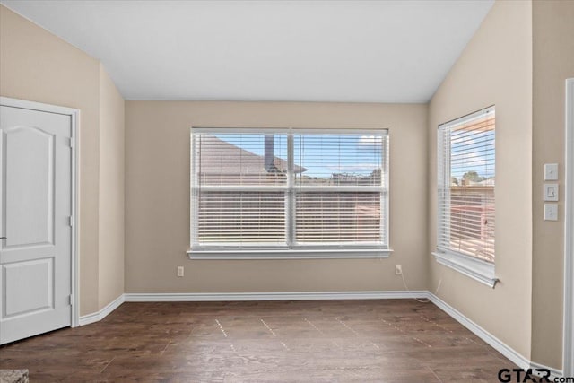 empty room featuring vaulted ceiling