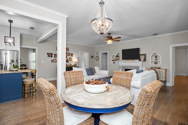dining room featuring ceiling fan with notable chandelier, dark wood-type flooring, and visible vents