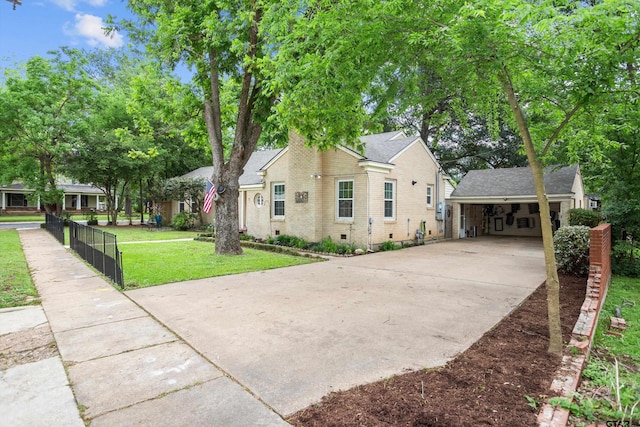 view of home's exterior with a yard, a carport, brick siding, and driveway