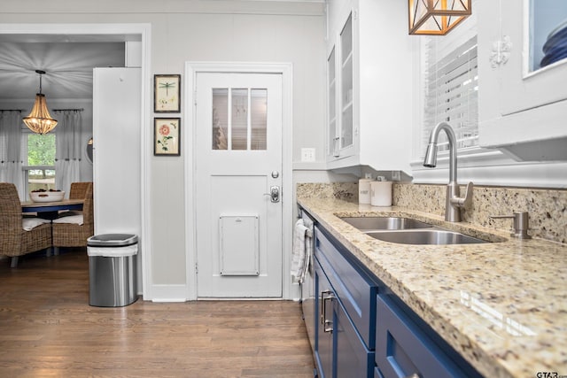 kitchen featuring a sink, a chandelier, blue cabinetry, and dark wood-type flooring