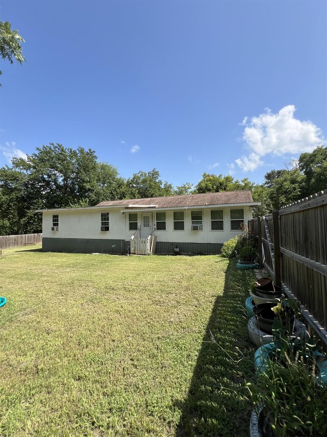 113 W Paschal St, Troup, TX 75789 - rear view of property with a fenced backyard