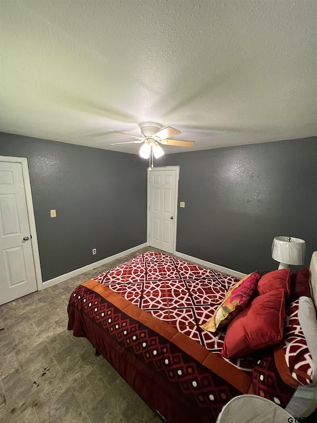 113 W Paschal St, Troup, TX 75789 - bedroom featuring a textured ceiling and a ceiling fan