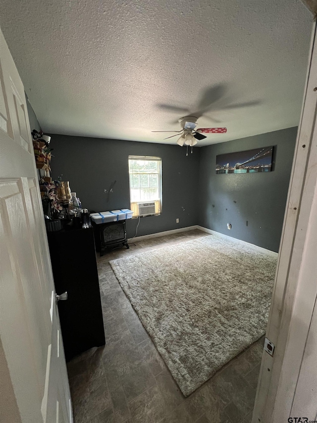 113 W Paschal St, Troup, TX 75789 - unfurnished bedroom featuring cooling unit, a textured ceiling, and ceiling fan