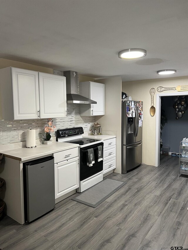 113 W Paschal St, Troup, TX 75789 - kitchen with stainless steel fridge with ice dispenser, electric range, wall chimney range hood, and backsplash