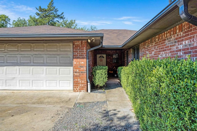 doorway to property with a garage