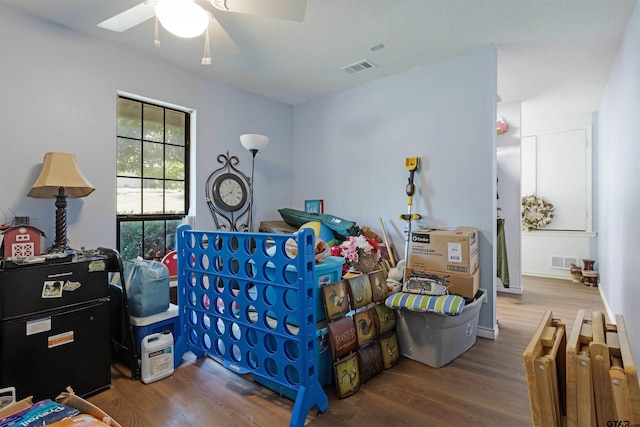 bedroom with wood-type flooring and ceiling fan